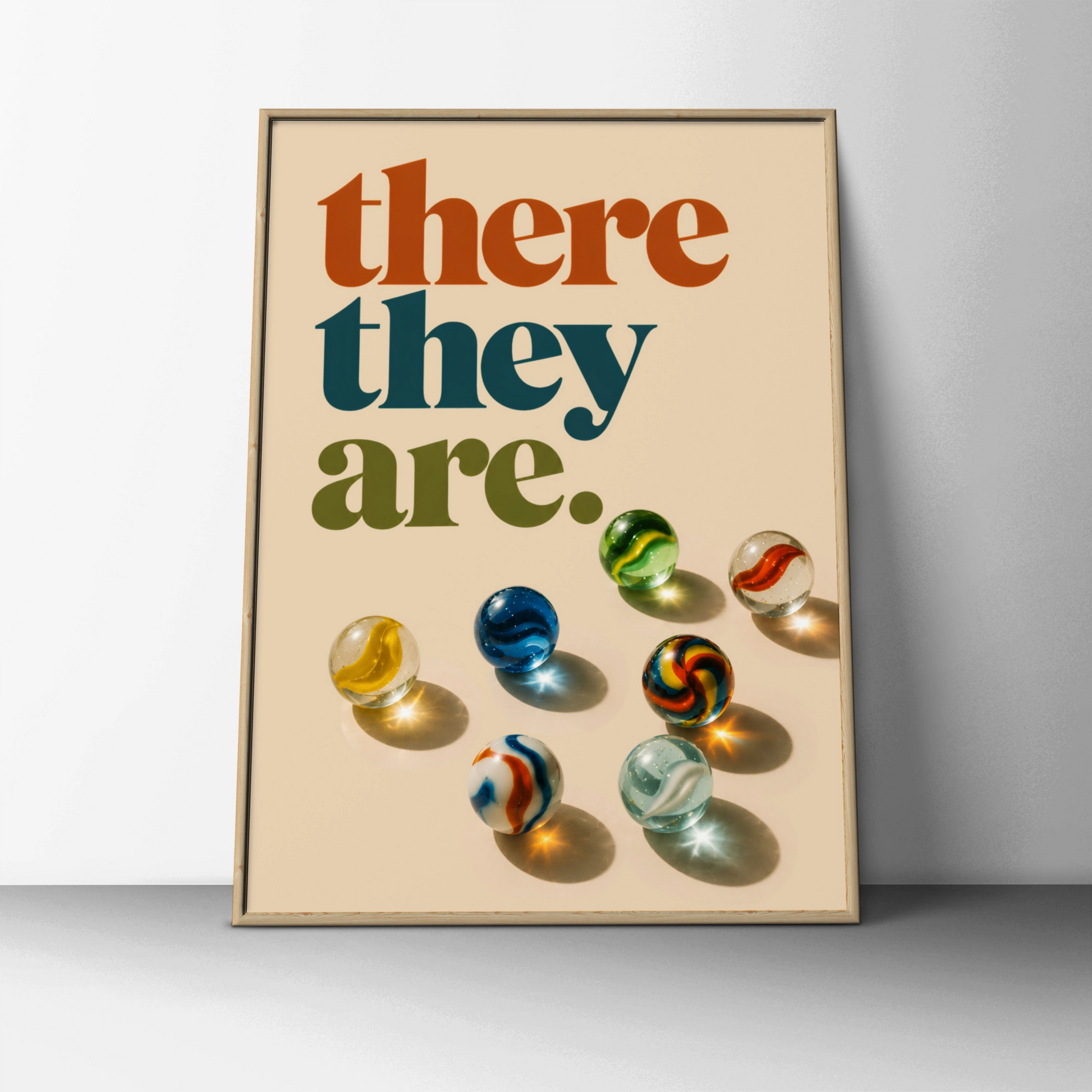 Retro there they are quote above colourful glass marbles on cream