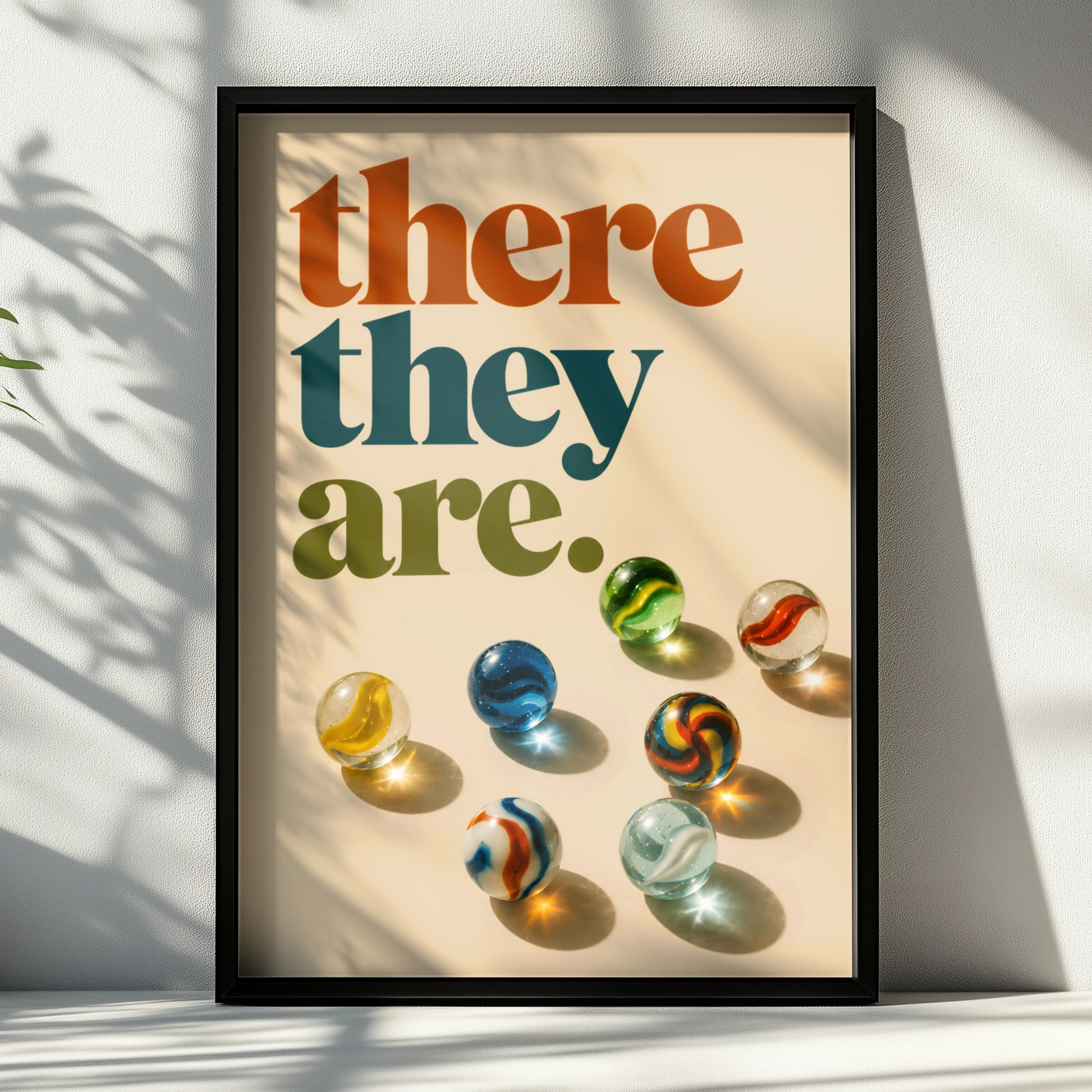 Retro there they are quote above colourful glass marbles on cream
