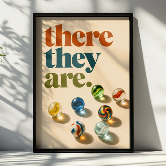 Retro there they are quote above colourful glass marbles on cream