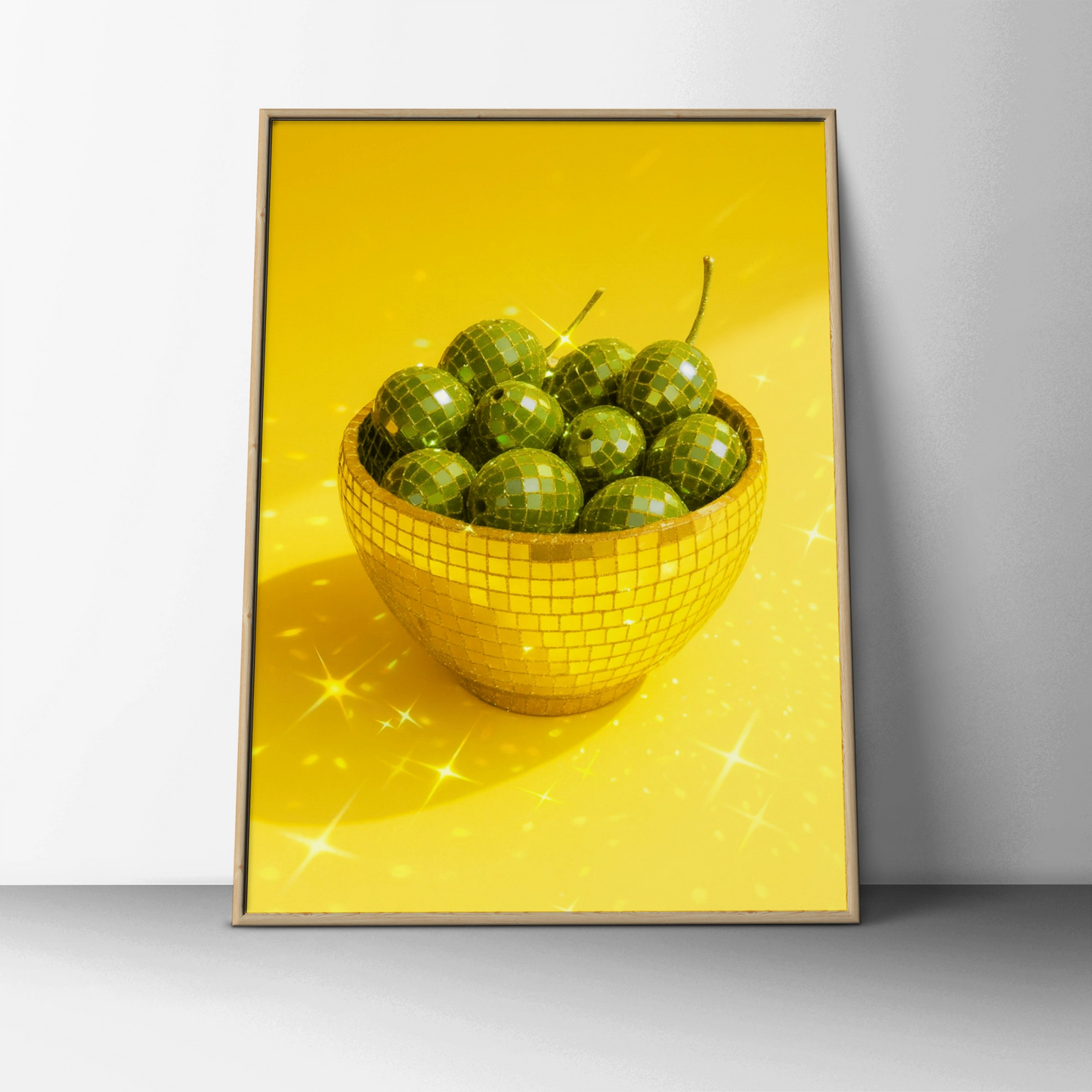 Gold disco mosaic bowl filled with green olives on a yellow background