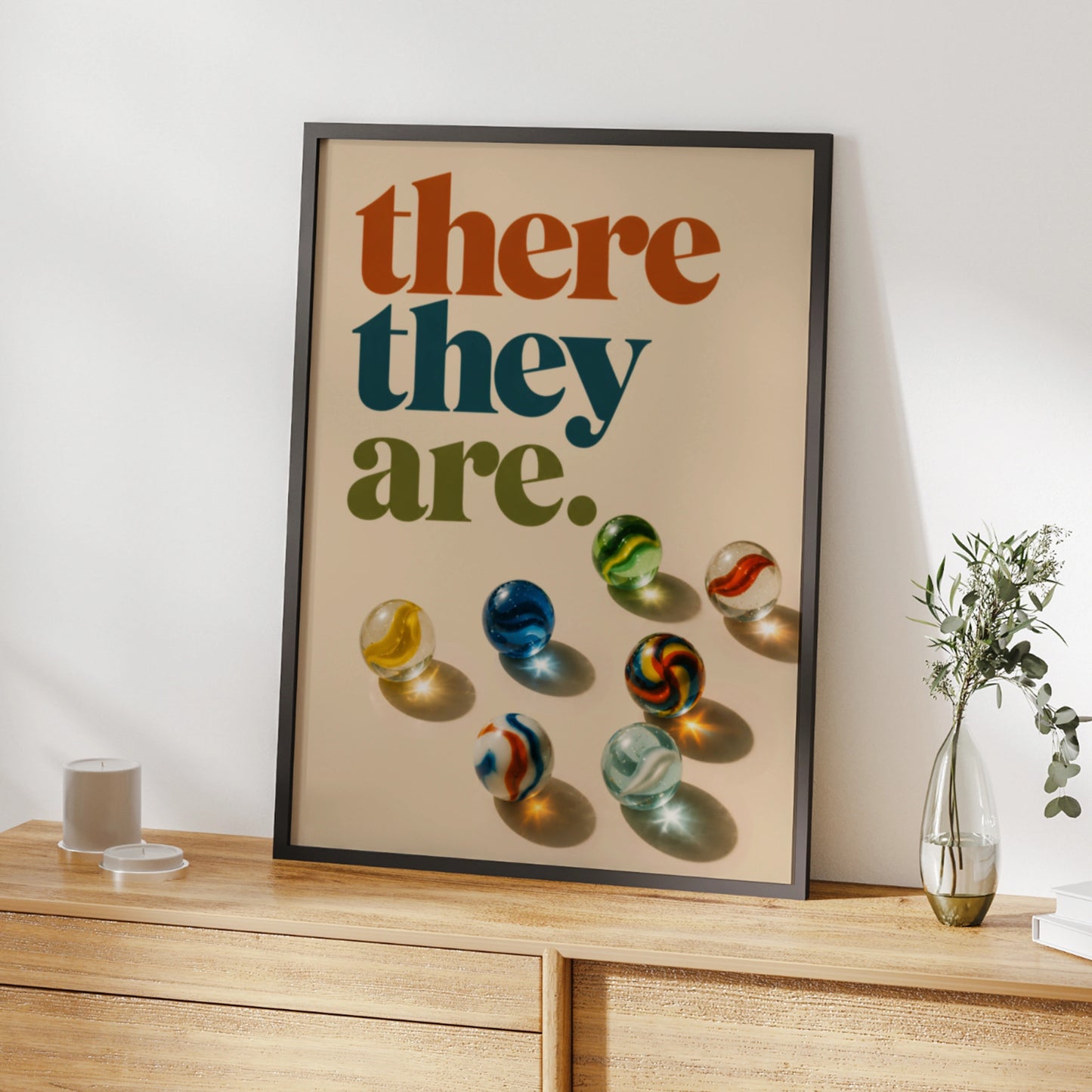 Retro there they are quote above colourful glass marbles on cream