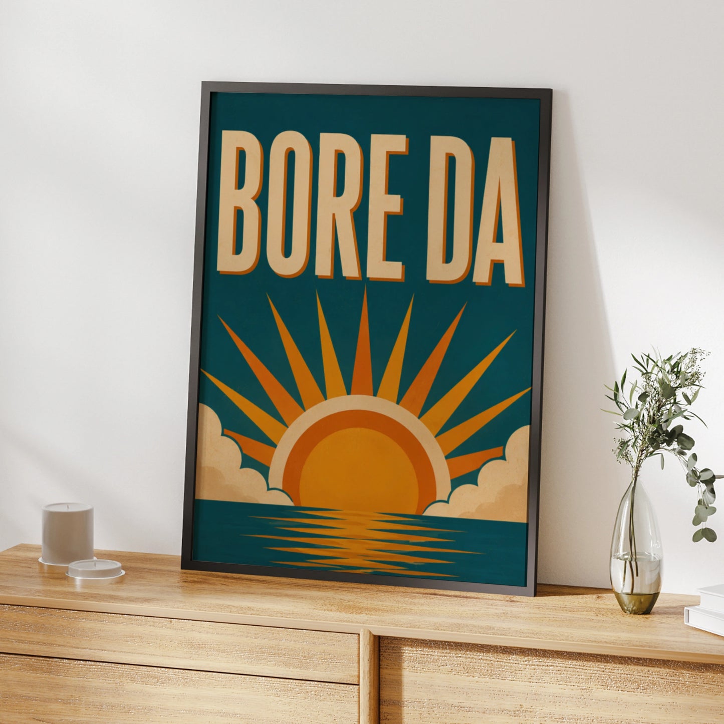 Bore Da Welsh poster with cream lettering and orange sunrise over a teal-blue sea