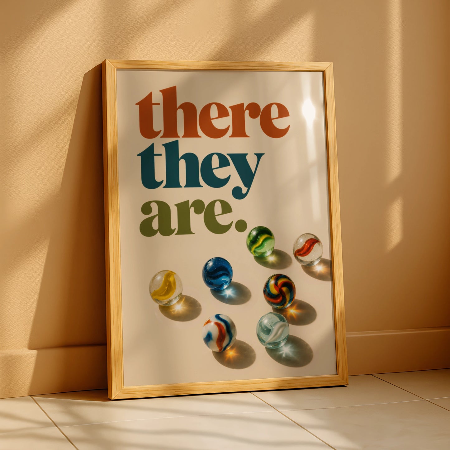 Retro there they are quote above colourful glass marbles on cream