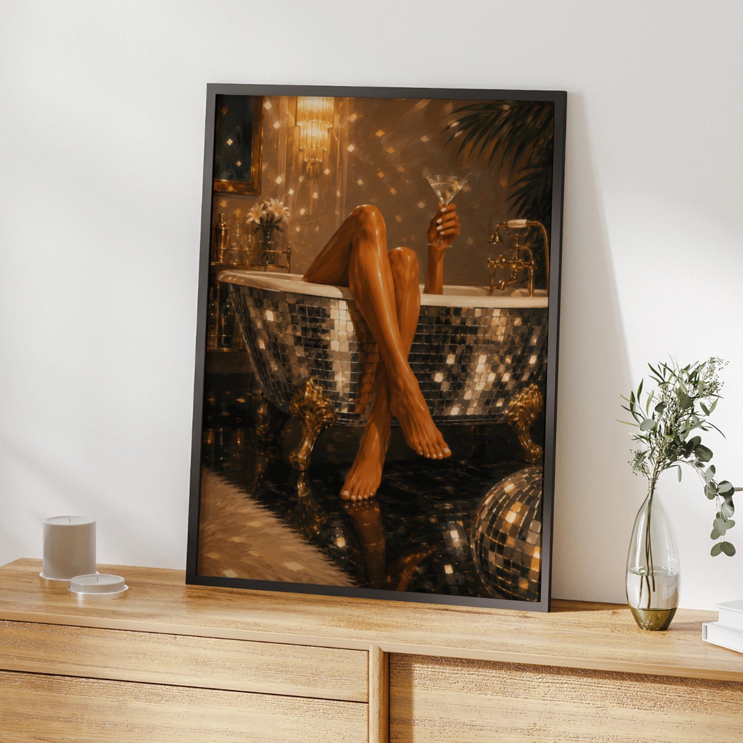 Glamorous woman holding a martini in a mirrored bath with gold decor
